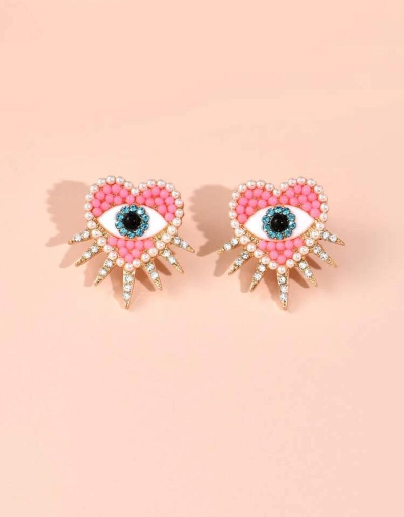 Ivy oorbellen ingelegd met strass zirkonia stenen met de kleuren goud wit blauw en roze in de vorm van een hart met oogje en stekels