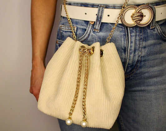 handtas van ribstof met goud en parels